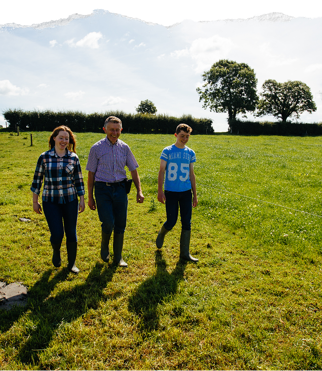 Organic farming family in Ireland walking through green fields